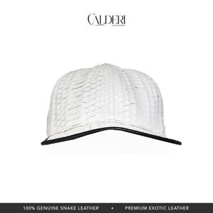 May include: A white baseball cap with a textured pattern, featuring a black brim. The cap is made of genuine snake leather. The brand name "CALDERI" is visible at the top.