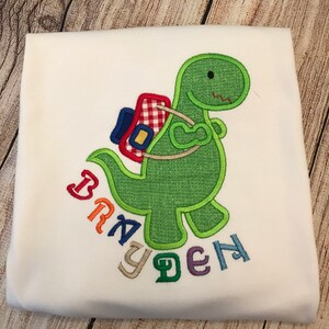 Back-To-School Dinosaur Tee Shirt. Dino with Backpack. Applique T-Rex.
