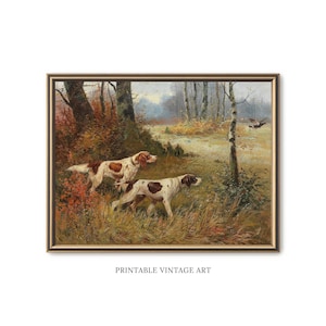 Może przedstawiać: Oprawiony, zabytkowy wydruk przedstawiający dwa psy rasy setter angielski w leśnej scenerii. Psy są białe z brązowymi plamami, na tle jesiennych liści i drzew. Wydruk oznaczony jest napisem "PRINTABLE VINTAGE ART".