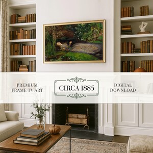 May include: A framed artwork with a gold border hangs above a fireplace. The painting depicts a person in a pond surrounded by greenery. The text "CIRCA 1885" is displayed below the artwork. Bookshelves flank the artwork, filled with antique books.