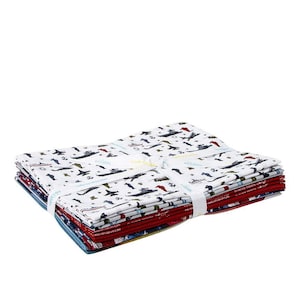 May include: A stack of 12 fabric squares with a white background and a colorful print of military vehicles, airplanes, and ships. The fabric squares are tied together with a white ribbon.