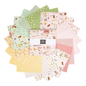 May include: A collection of fabric squares in various pastel colors, including yellow, green, and pink. The squares feature patterns of teddy bears, clouds, and polka dots. The text "BABY GIRL" is visible on a label.