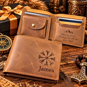 May include: A brown leather bifold wallet featuring a laser-engraved Vegvisir symbol and the name James on the front. The interior includes a coin pocket with a snap button and a card slot engraved with the text Wherever you go I'll always be with you Love, Dad.