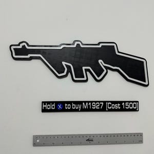 May include: A black and white silhouette of an M1927 submachine gun, a rectangular sign with the text "Hold X to buy M1927 [Cost 1500]", and a 30 cm ruler showing the scale of the items in centimetres and inches.