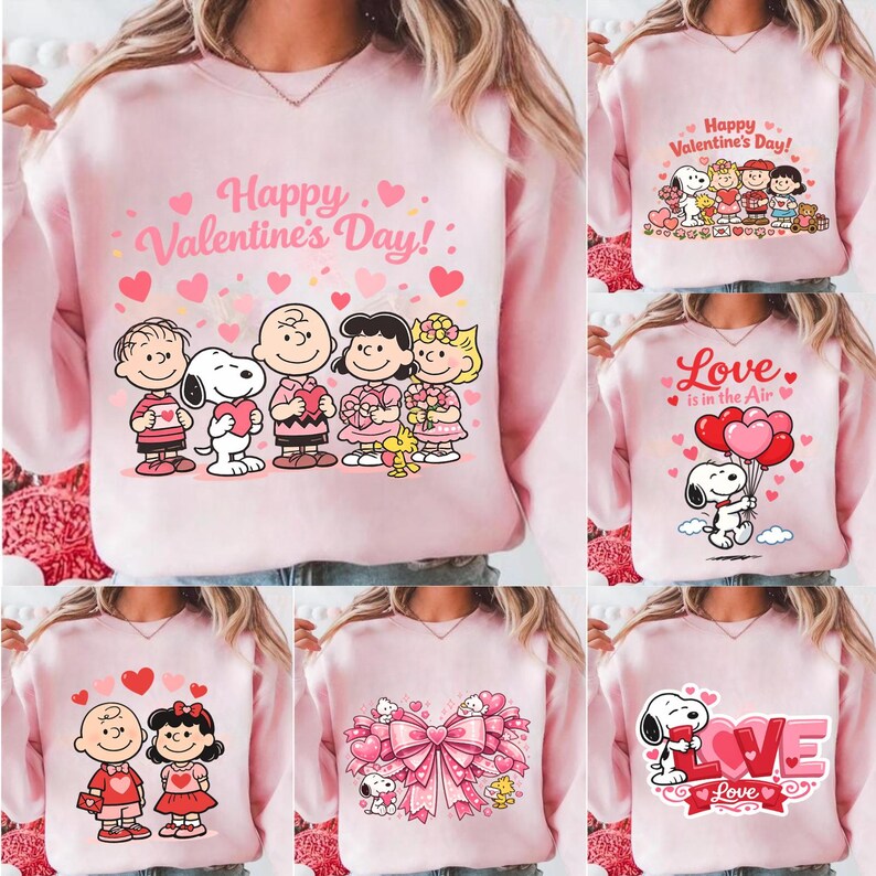 May include: Pink sweatshirts with Valentine's Day graphics. Designs include Snoopy and Peanuts characters with hearts and the phrases "Happy Valentine's Day!" and "Love is in the Air." The sweatshirts are a light pink color.