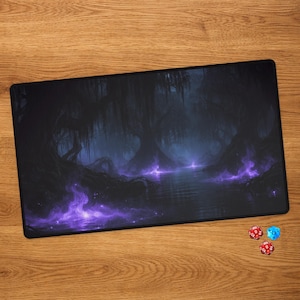 May include: A rectangular playmat featuring a dark, atmospheric swamp scene with silhouetted trees and glowing purple magical mist hovering over the water. Two twenty-sided dice, one red and one blue, are positioned near the bottom right corner.