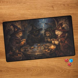 May include: A rectangular playmat featuring an illustration of four cats dressed as wizards sitting around a circular stone table playing cards in a dimly lit room. Two polyhedral dice, one red and one blue, are positioned below the mat.