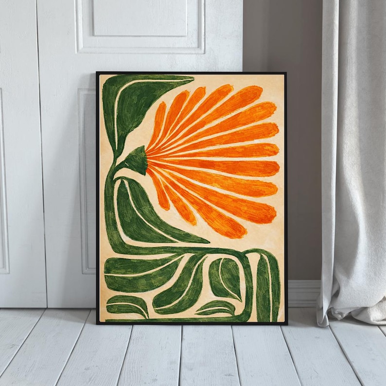 May include: Abstract floral art print featuring a large orange flower with green leaves and stem against a beige background. The artwork is framed in a black border, creating a striking contrast. The botanical illustration is a modern art piece.