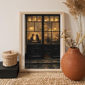 May include: A framed painting depicts a romantic scene of a couple dining in a warmly lit restaurant. The artwork features a dark, multi-paned door with a stone walkway. Soft, golden light emanates from the interior, creating a cozy and intimate atmosphere.