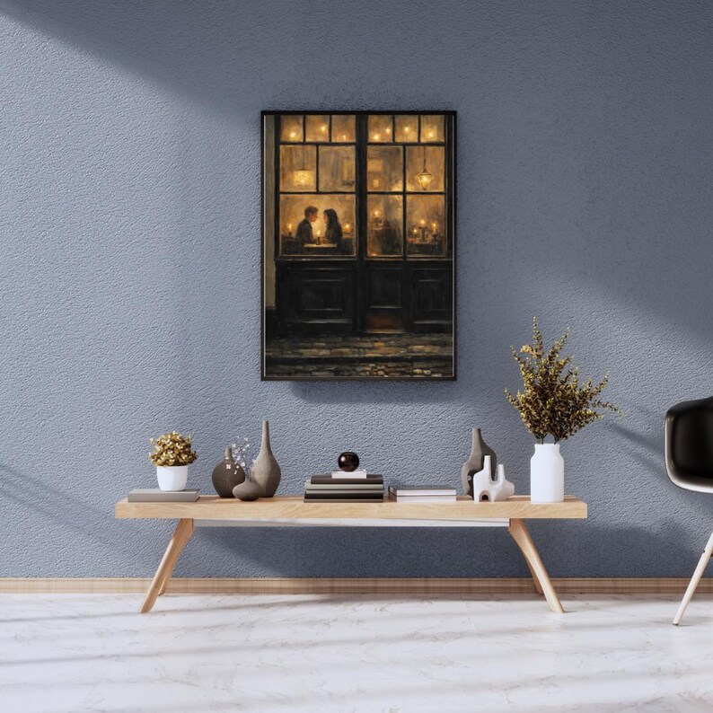 May include: A framed artwork depicts a romantic scene of a couple dining in a warmly lit restaurant. The painting is set against a dark, detailed door and window frame. The artwork is displayed above a wooden coffee table with decorative vases and a small plant.
