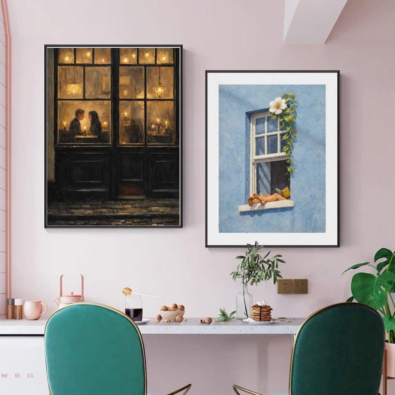 May include: Two framed art prints. One depicts a couple dining in a warmly lit restaurant. The other shows a person relaxing in a window with a white flower and green vines against a blue wall. The prints are displayed above a table with green chairs.