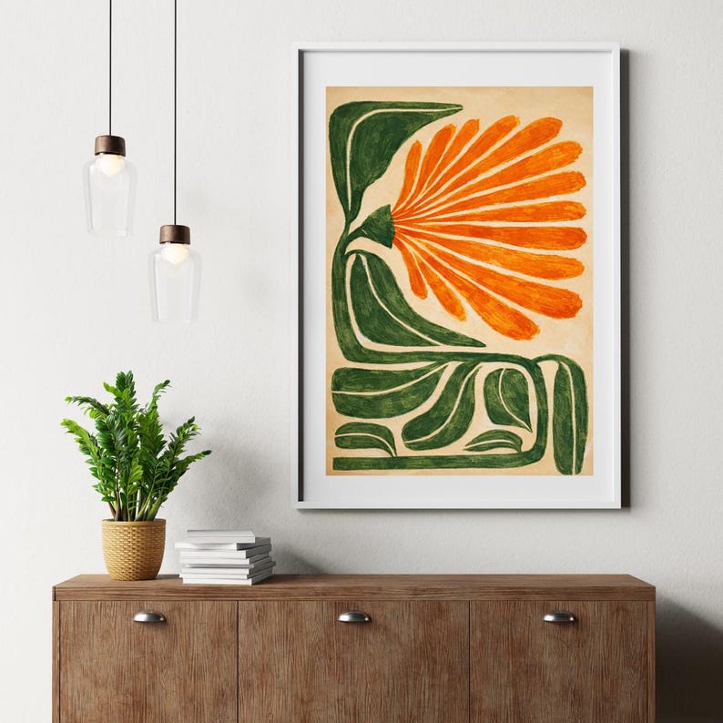 May include: A framed art print featuring a stylized floral design. The artwork showcases a large orange flower with green leaves and stems against a beige background. The print is displayed in a white frame, adding a modern touch to the botanical theme.