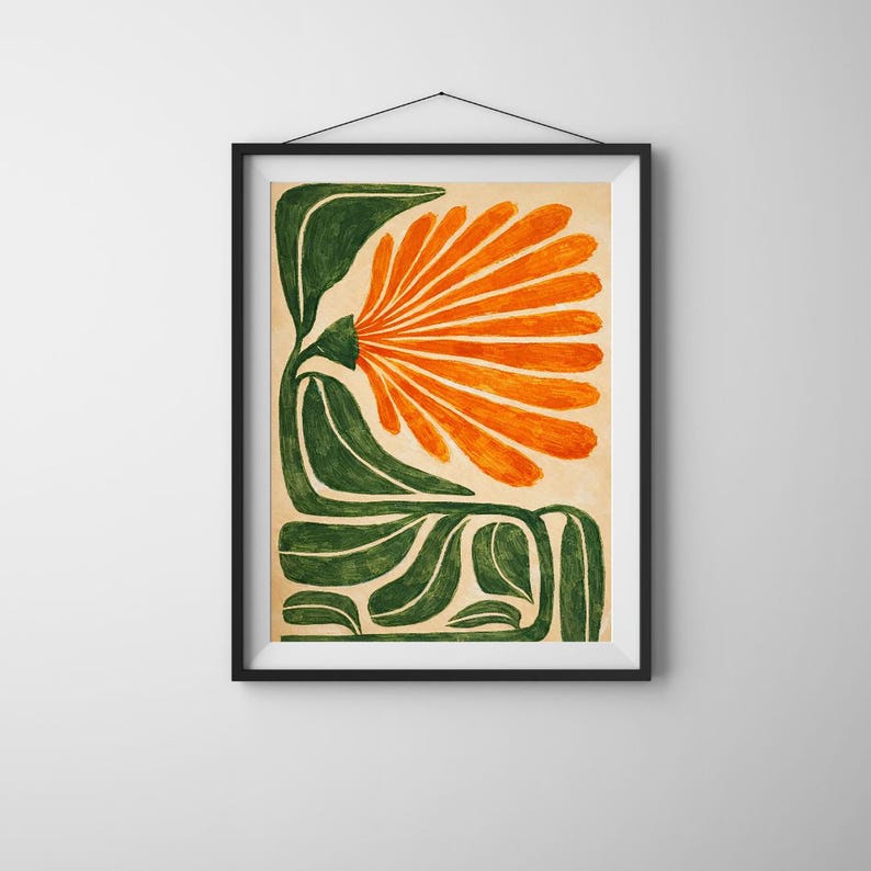May include: Framed art print featuring a stylized floral design. The artwork showcases a large orange flower with radiating petals, set against a beige background. The flower is supported by green, curved leaves and stems. The print is encased in a black frame.