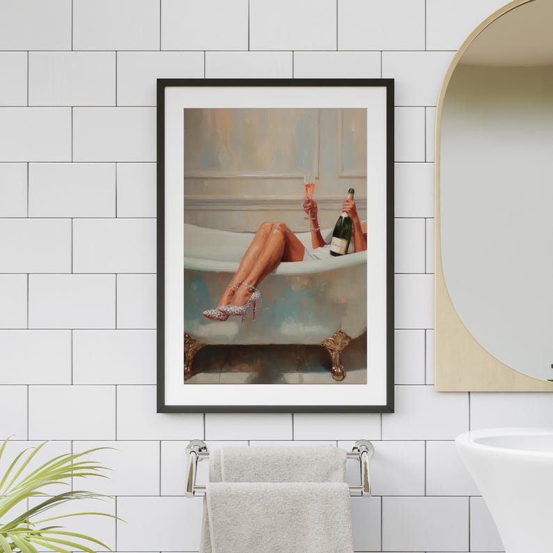 May include: Framed art print of a woman in a bathtub, holding a champagne bottle and a glass. She wears high heels with sparkling embellishments. The artwork has a vintage aesthetic, with a light color palette and ornate bathtub.