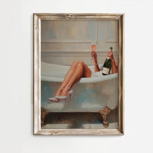 May include: Framed artwork depicts a person relaxing in a bathtub, holding a champagne bottle and a glass of champagne. The person is wearing sparkling high heels. The artwork has a vintage aesthetic with a neutral color palette.