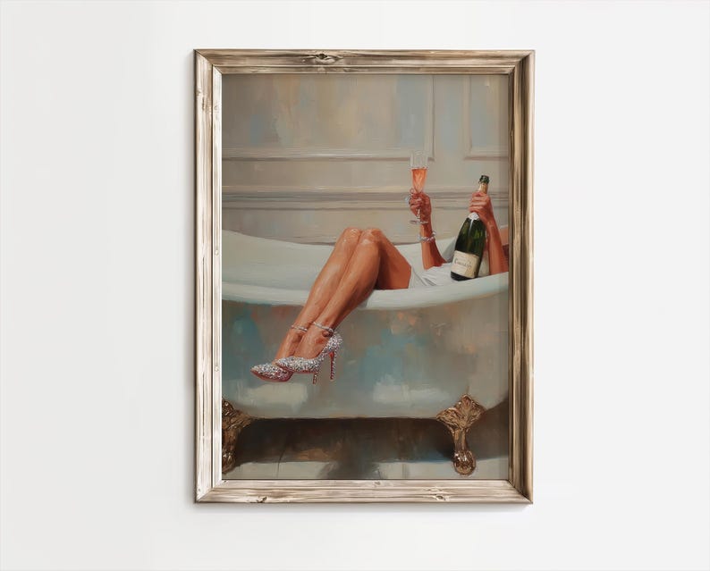 May include: Framed artwork depicts a person relaxing in a bathtub, holding a champagne bottle and a glass of champagne. The person is wearing sparkling high heels. The artwork has a vintage aesthetic with a neutral color palette.