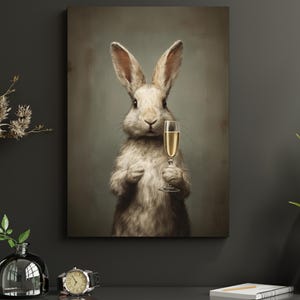 May include: A canvas print features a white rabbit holding a champagne flute. The rabbit has long ears and a fluffy coat. The background is a muted green, creating a vintage aesthetic. The rabbit is the focal point of the artwork.