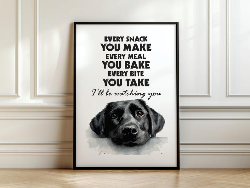 May include: Black framed art print featuring a watercolor image of a black Labrador Retriever dog. The print includes the text: "EVERY SNACK YOU MAKE, EVERY MEAL YOU BAKE, EVERY BITE YOU TAKE, I'll be watching you."