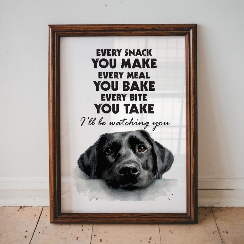 May include: Framed print featuring a black Labrador Retriever with the text "Every snack you make, every meal you bake, every bite you take, I'll be watching you." The frame is a dark brown color.