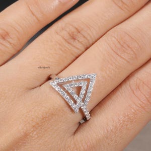 triangle diamond ring
geometric ring
white gold ring
open triangle ring
modern statement ring
minimalist jewelry
pave diamond ring
unique engagement ring
anniversary gift
luxury ring
architectural ring
gift for her
modern bridal ring
triangle ring
geometric jewelry
open design ring
pave diamond ring
white gold jewelry
modern gold ring
statement jewelry
minimalist ring
contemporary ring
architectural ring
unique ring design
fashion ring
gift for women
anniversary jewelry
bridal statement ring