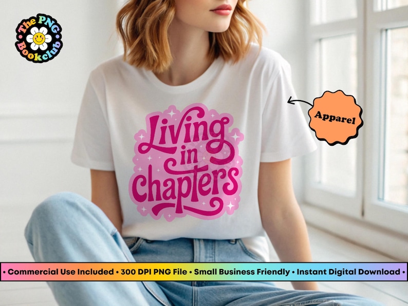 May include: A white short-sleeved t-shirt featuring a pink graphic design on the chest with the text Living in chapters. The design includes small star accents and a light pink outline. The shirt is paired with blue denim jeans.