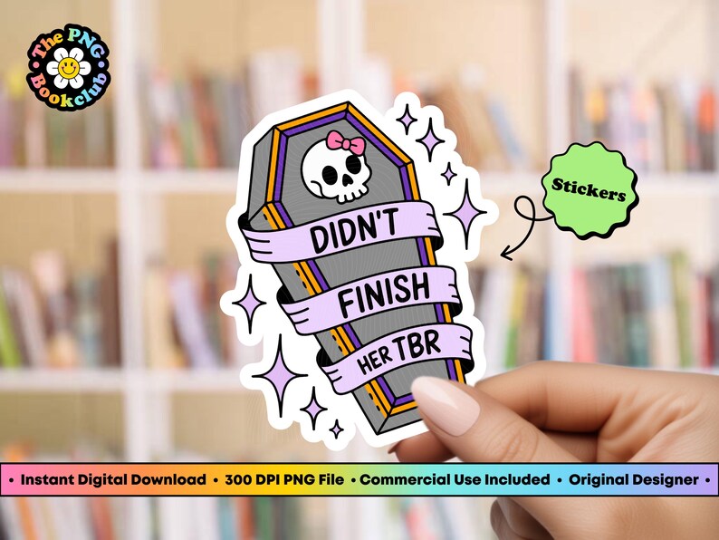 May include: A sticker featuring a coffin design with a skull wearing a pink bow. The coffin has a banner that reads "DIDN'T FINISH HER TBR". The sticker is held by a hand. The background is a bookshelf.