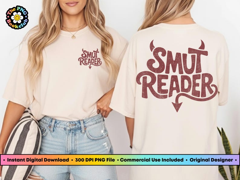 May include: Cream-colored t-shirt with the text "SMUT READER" in a retro font, featuring a devil's tail and horns design. The shirt is worn with denim shorts.