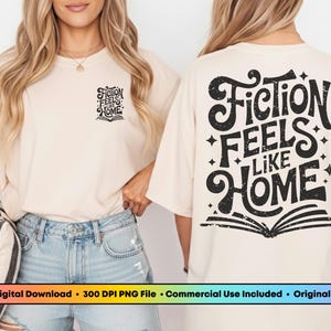 May include: Beige t-shirt with the text "Fiction Feels Like Home" in black, with a book graphic. The shirt is worn by a person in light-wash denim shorts. The PNG Bookclub logo is in the top left corner.