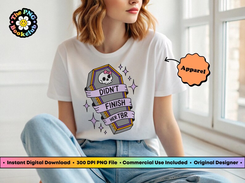May include: White t-shirt with a coffin graphic. The coffin has a skull with a pink bow and the words "Didn't Finish Her TBR" on a banner. The shirt is part of the apparel category.