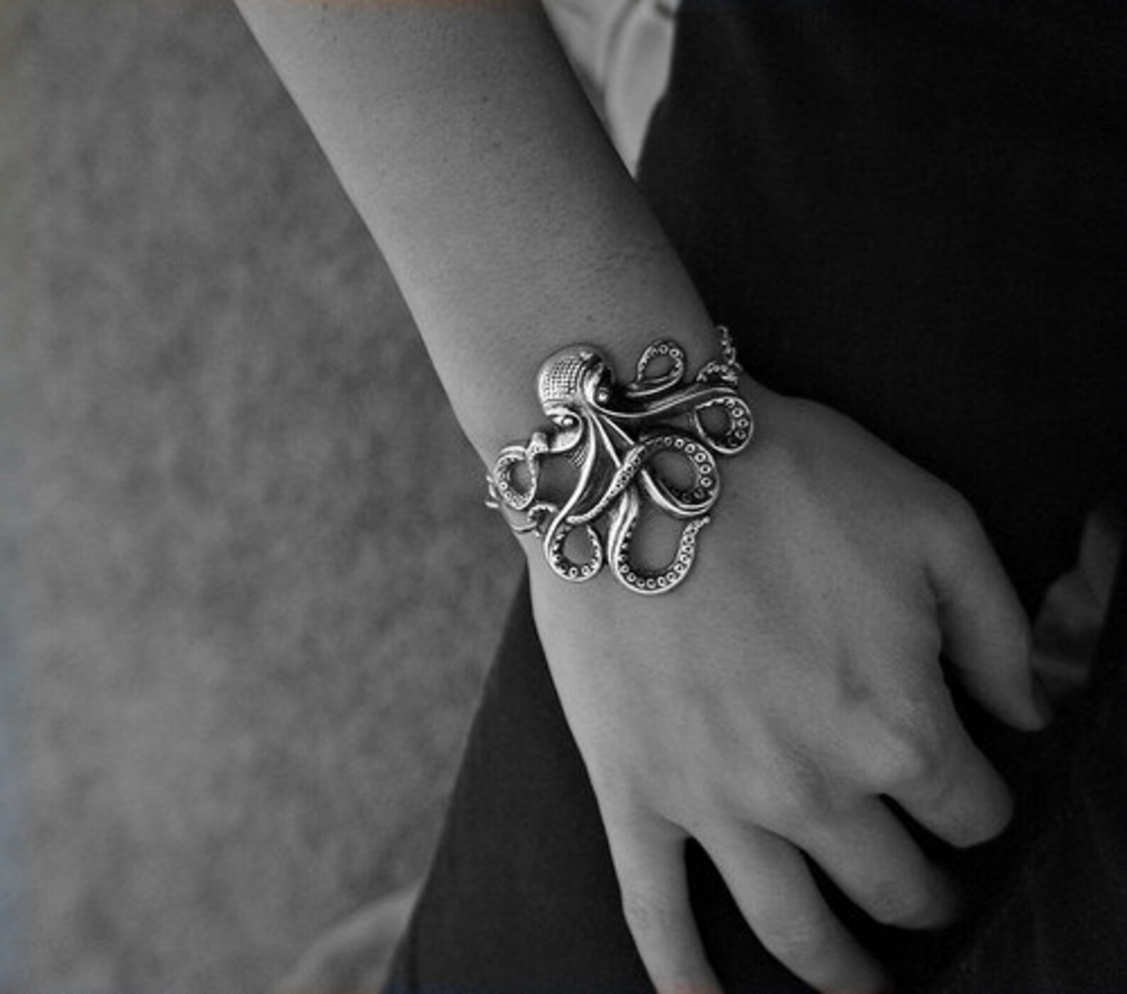 silver octopus bracelet on a woman's wrist