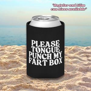 May include: A black foam beverage can cooler featuring the white text "PLEASE TONGUE PUNCH MY FART BOX" printed on the front. The top of a silver aluminum can is visible. The text "Regular and Slim can sizes available" appears at the top right.