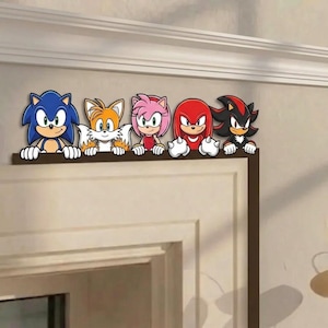 May include: A set of five decorative wall decals featuring the characters Sonic the Hedgehog, Tails, Amy Rose, Knuckles the Echidna, and Shadow the Hedgehog. Each character is depicted from the waist up, resting their hands on a horizontal edge.