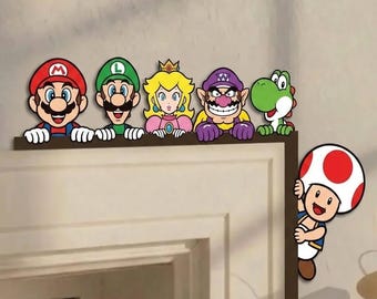 May include: A set of decorative wall decals featuring Mario, Luigi, Princess Peach, Wario, and Yoshi lined up along the top edge of a door frame, with Toad positioned on the side edge, all depicted in their classic colorful character designs.