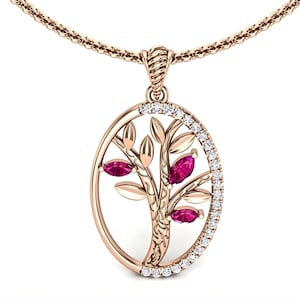 May include: Rose gold pendant necklace featuring an oval tree of life design. The tree has pink gemstone leaves and is outlined with small white gemstones. The pendant hangs from a delicate rose gold chain.