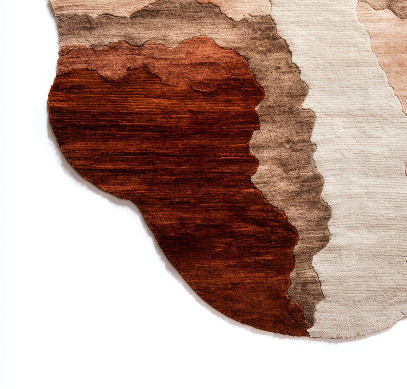 A close-up of the bottom left corner of the irregular rug, showing dark brown, light brown, and beige wavy sections.