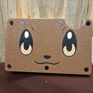 May include: A set of three ceramic mugs with a speckled, matte finish. The mugs are in shades of cream, light gray, and dark gray. Each mug has a simple, minimalist design, perfect for coffee or tea.