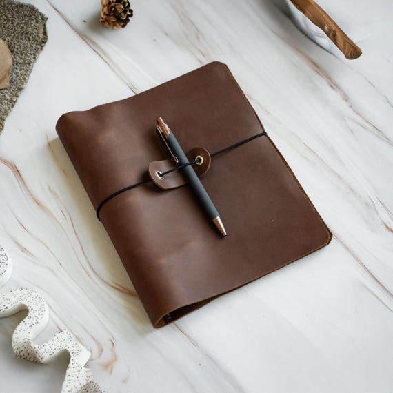 A hand-crafted leather 6-ring binder journal with monogramming — the kind of desk object that feels like a serious heirloom stationery piece.