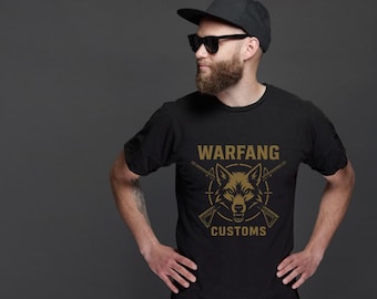 May include: Black t-shirt with a gold wolf graphic and the text "WARFANG CUSTOMS". The design features a wolf's head, crossed rifles, and a circular border. The shirt is made of a soft material.