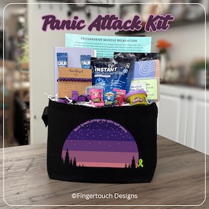 May include: A black canvas bag with a sunset and forest graphic and the text Each breath brings me calm and peace. The bag contains a Panic Attack Kit with an instant cold compress, Play-Doh, a purple bead bracelet, a fidget toy, and informational cards.