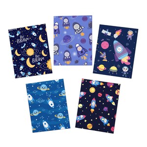 May include: Five space-themed notebooks with various designs. Each notebook features rockets, planets, stars, and moons. One notebook has the text "Be Brave". The colour scheme includes blues, purples, yellows, and oranges.