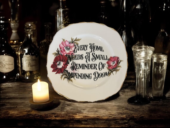 Every home needs a small reminder of impending doom, vintage plate with stand