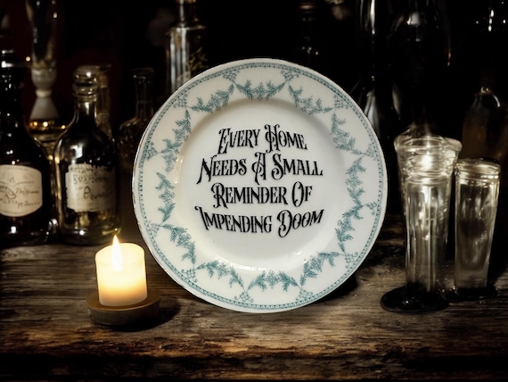 Every home needs a small reminder of impending doom, vintage plate with stand