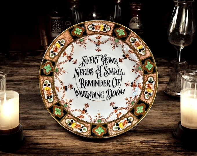 Every home needs a small reminder of impending doom, vintage plate with stand
