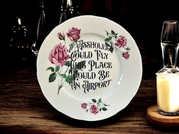 If assholes could fly this place would be an airport, vintage plate with stand