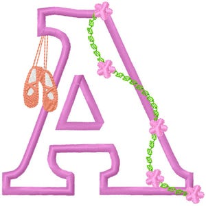 May include: A pink embroidered letter "A" with a pair of ballet shoes hanging from the top. The letter is decorated with a green vine and pink flowers, creating a whimsical design.