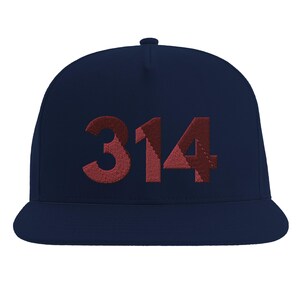 May include: A navy blue baseball cap featuring the number 314 embroidered on the front in a dark red, textured, multi-tonal fabric. The cap has a structured crown, a flat brim, and a button at the top center, showcasing a clean, solid design.