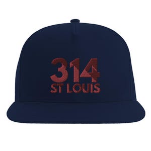 May include: A navy blue baseball cap featuring embroidered text in a dark red hue. The front of the cap displays the number 314 in a large font, with the words ST LOUIS positioned directly underneath in a smaller, matching red embroidered font.