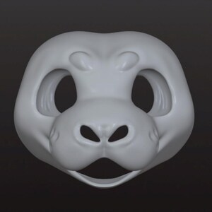 May include: A light gray, smooth, sculpted animal mask base featuring large, rounded eye sockets, a prominent snout with two nostril openings, and an open mouth area. The mask has a rounded, symmetrical shape with defined brow ridges.