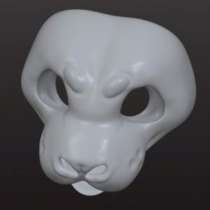 May include: A light gray, smooth, three-dimensional animal mask base featuring large, hollow eye sockets, a rounded snout area with a defined nose bridge, and a small opening at the mouth. The surface is matte and uniform in color throughout the structure.