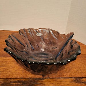 May include: A handmade, wooden serving tray with a natural finish. The tray features a rectangular shape with raised edges and two handles. The wood grain is visible, showcasing the tray's rustic charm. Perfect for serving food or displaying decor.